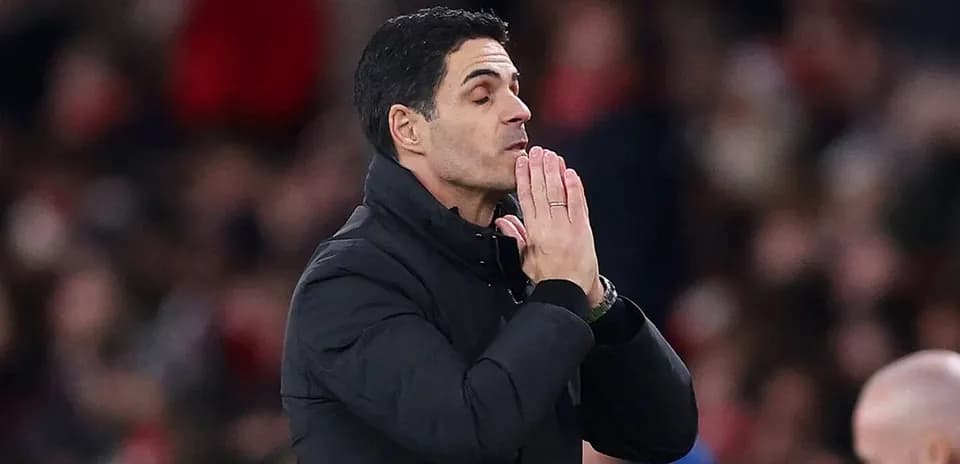 Manager with hands together during match