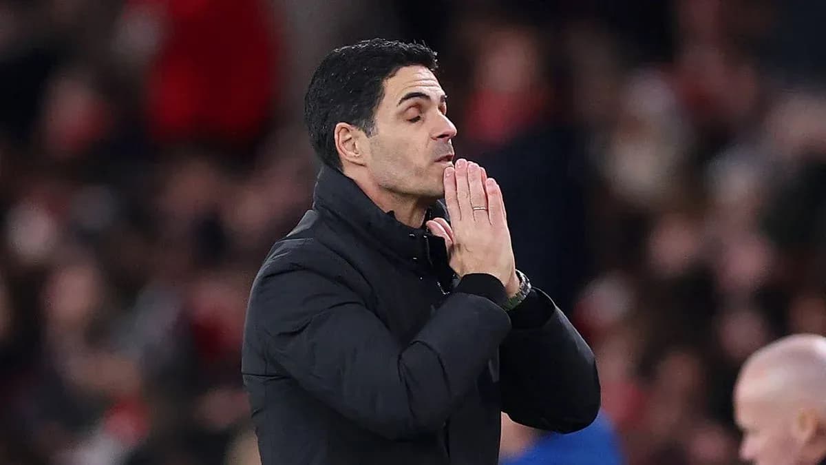 Manager with hands together during match