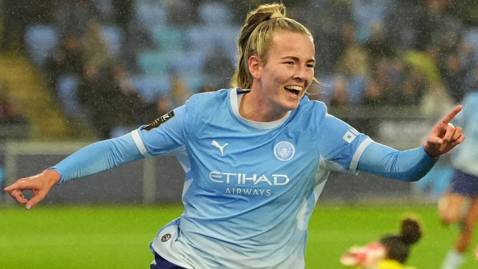 Player celebrating a goal in Manchester City kit