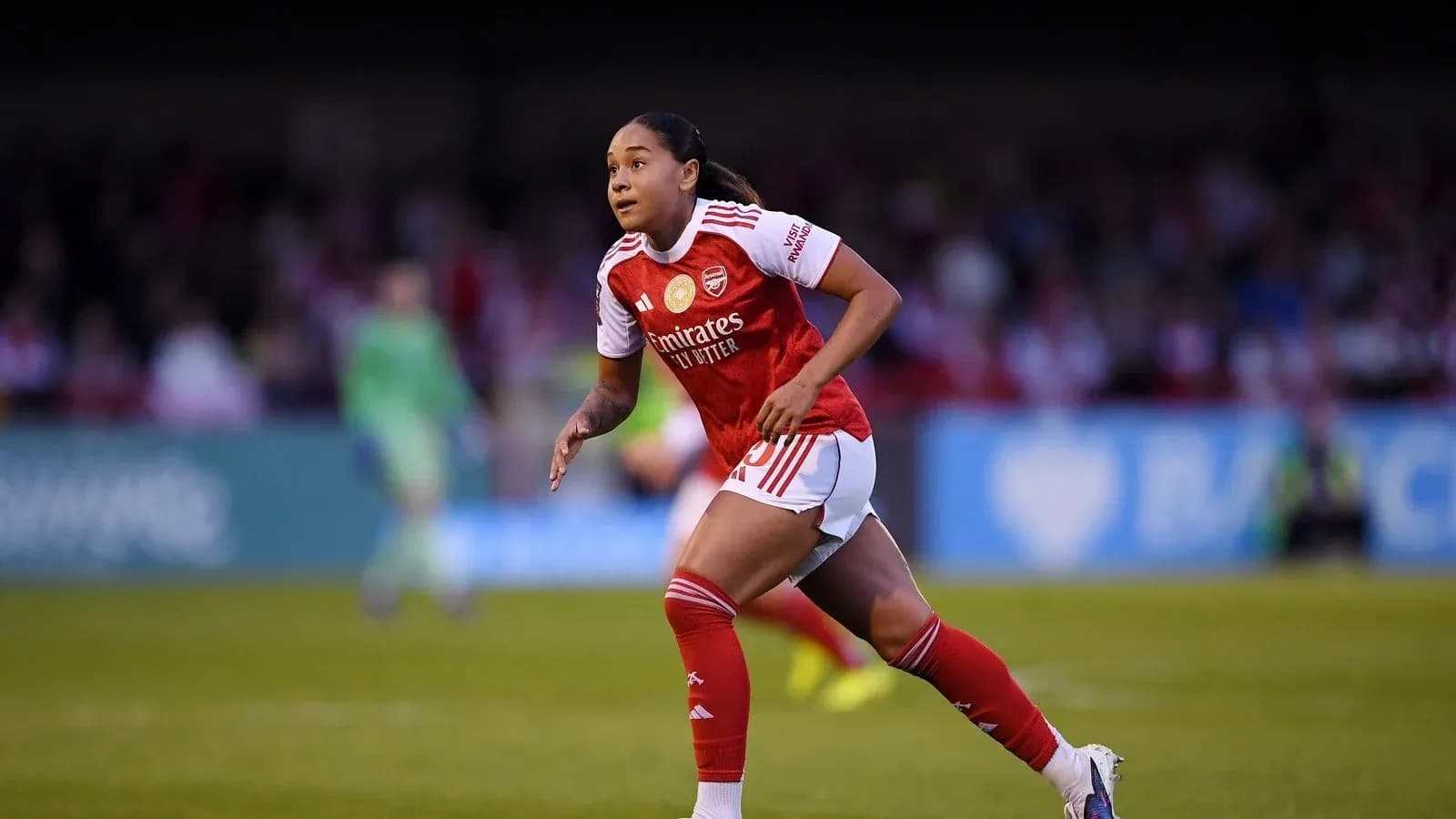 Player in Arsenal kit running on the pitch