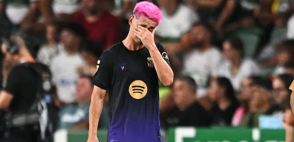 Player with pink hair walking off field in distress