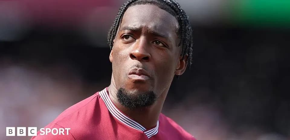 Player in maroon jersey looking towards the field