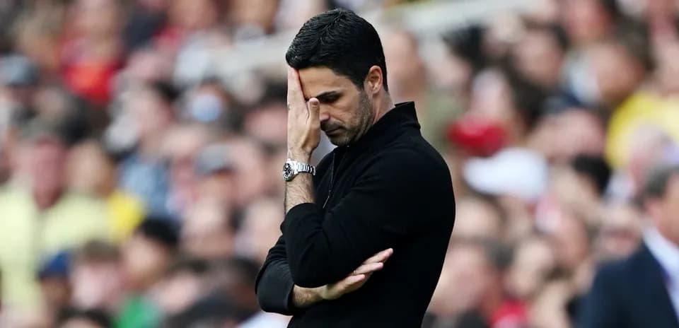 Manager with hand on face during match