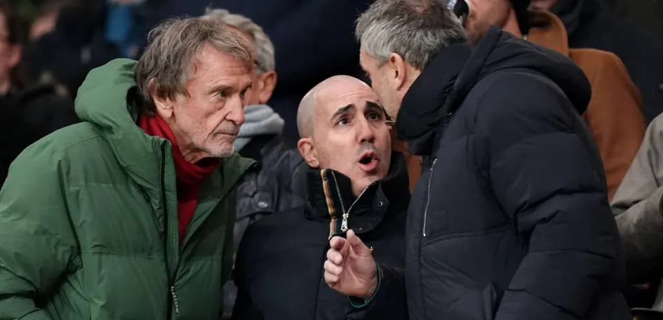Three fans engaged in conversation during a match