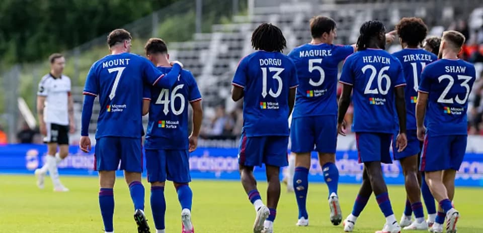 Team celebrating with player after scoring goal