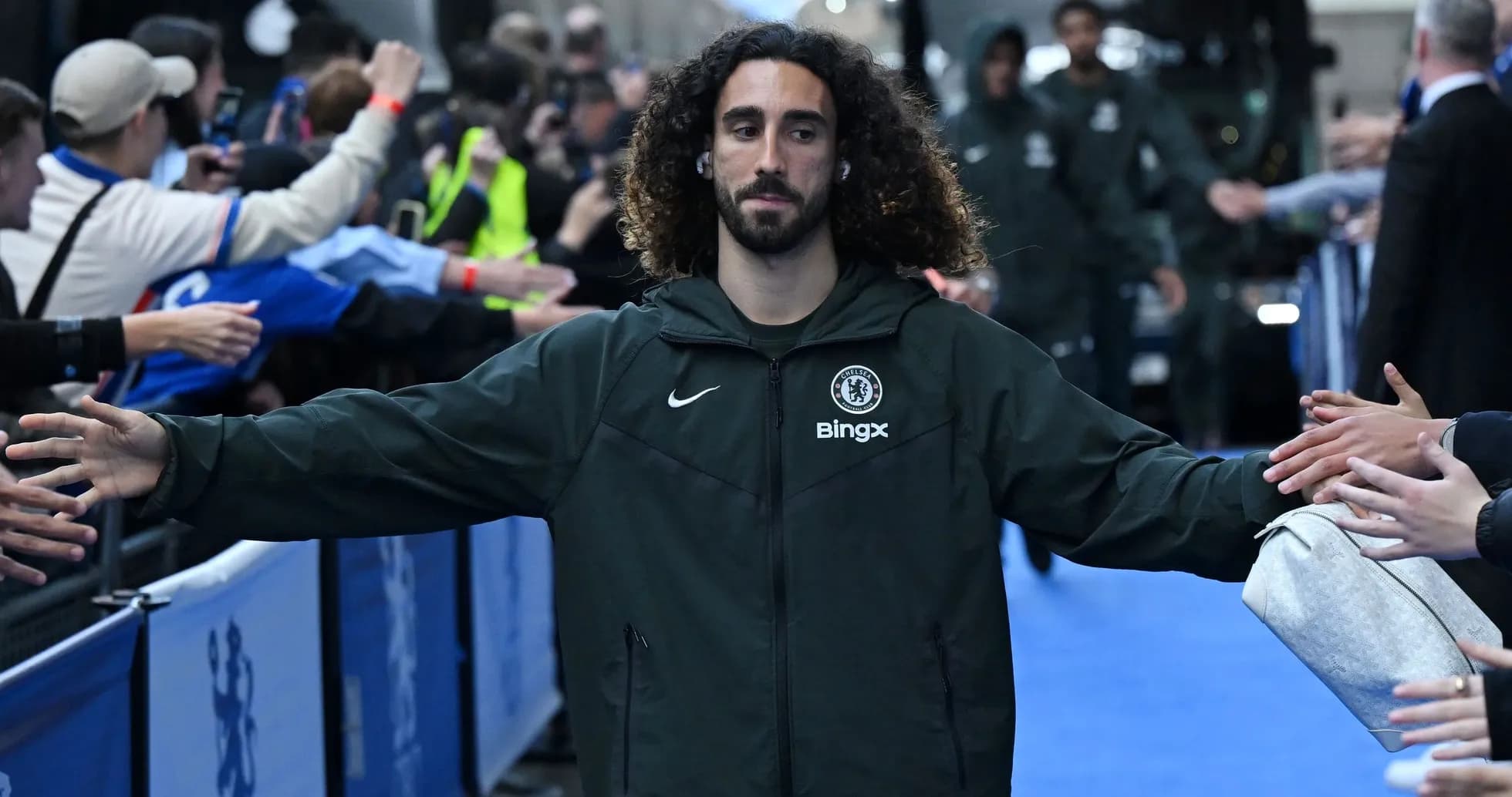 Player greeting fans while entering stadium