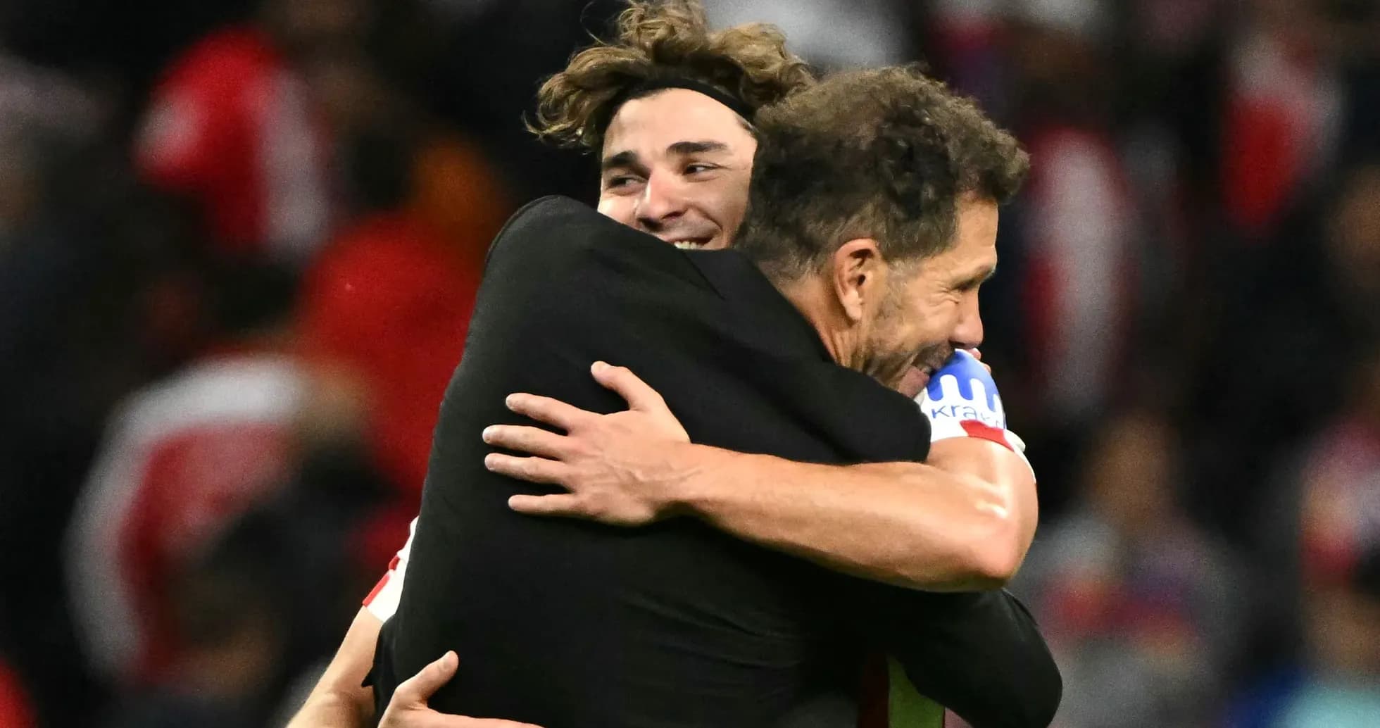 Two players embracing after a match victory