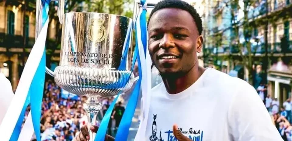 Player celebrating with trophy during victory parade