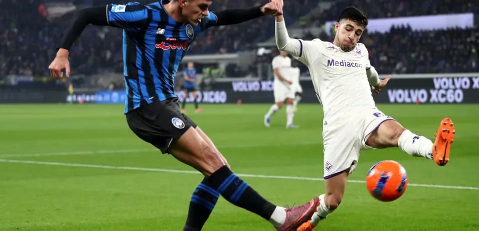 Fiorentina player tackling Atalanta opponent