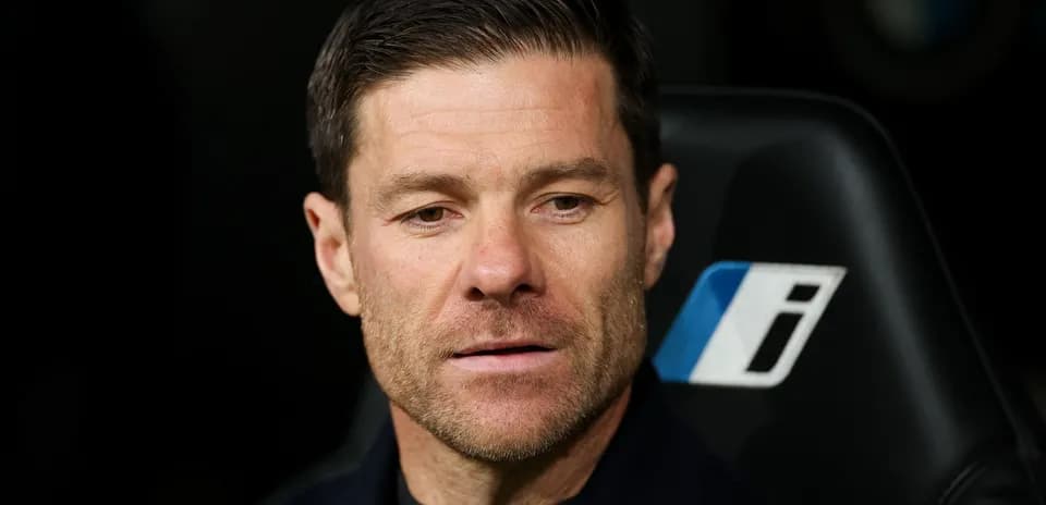 Coach seated on bench during match observation