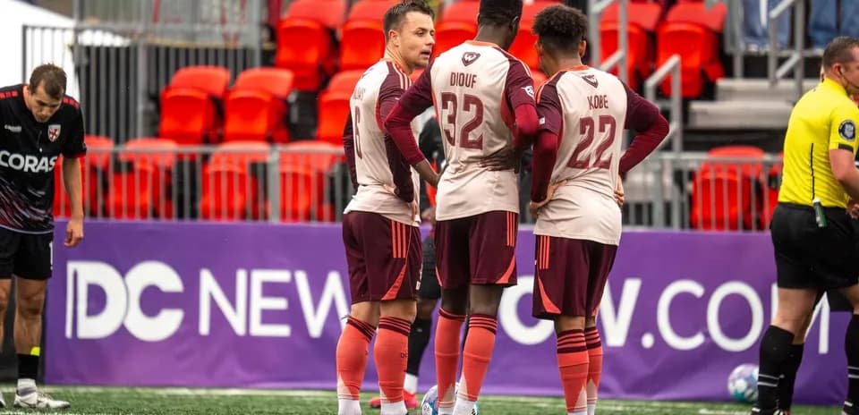 Detroit City players strategizing before the match