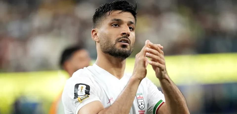 Player applauding fans after match in stadium