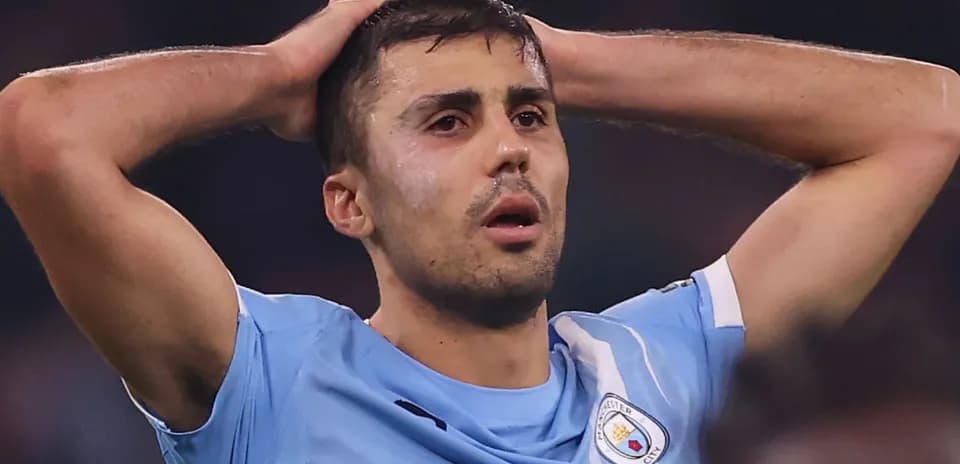 Player holding head in disappointment on field