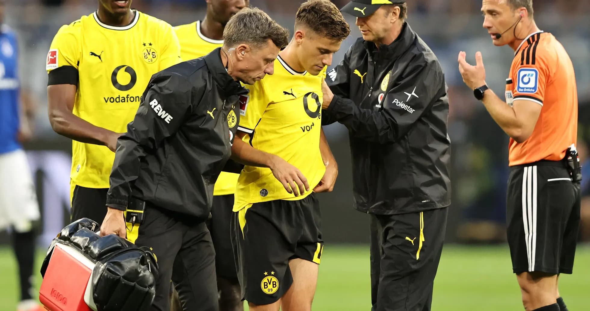 Borussia Dortmund player receiving medical attention on field