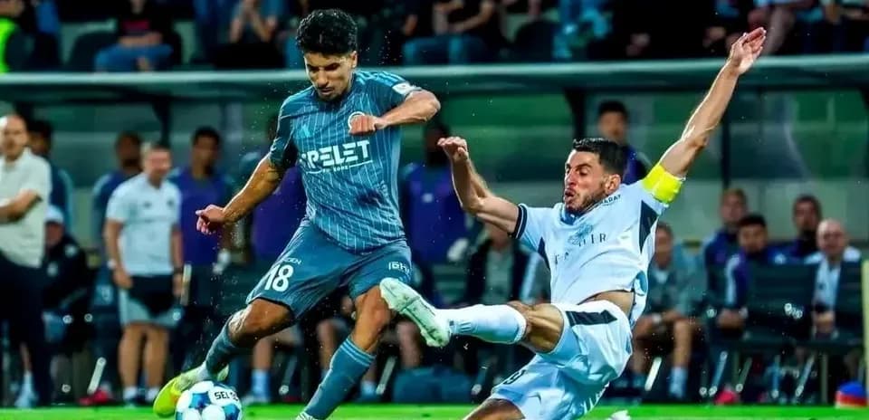 Player tackling during Hapoel Beer Sheva match