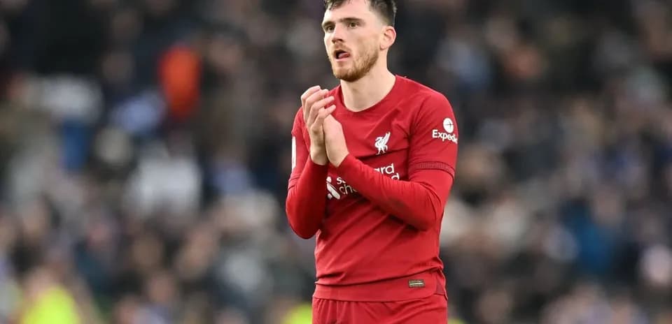 Player in Liverpool kit clapping to fans
