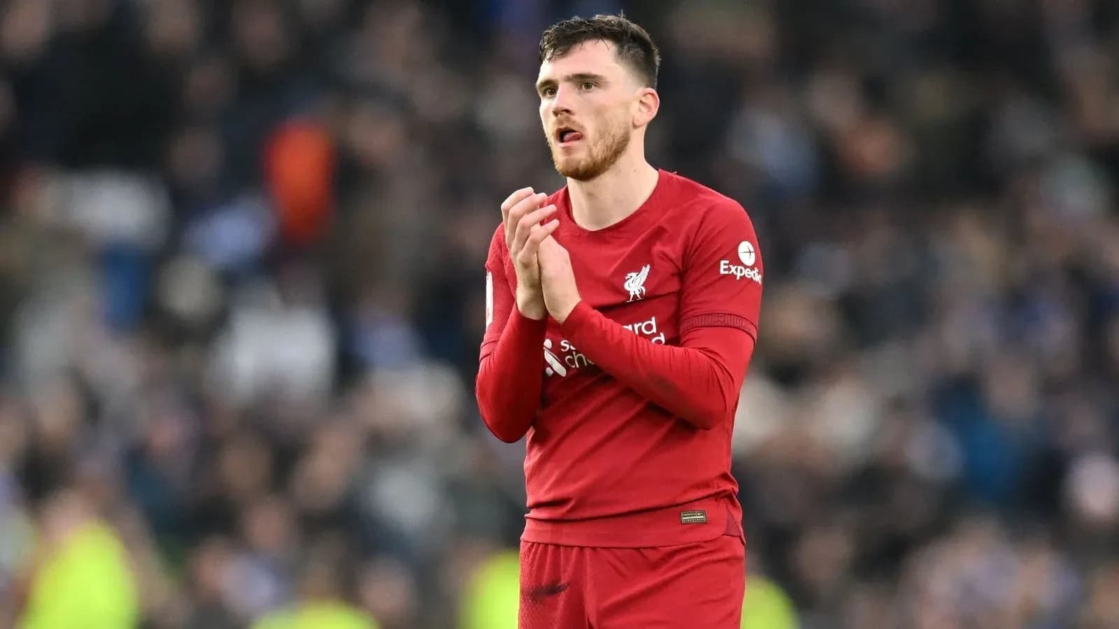 Player in Liverpool kit clapping to fans