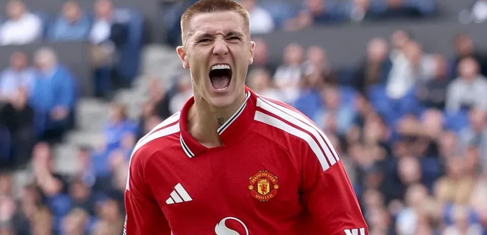 Goalkeeper celebrating a save in Manchester United jersey