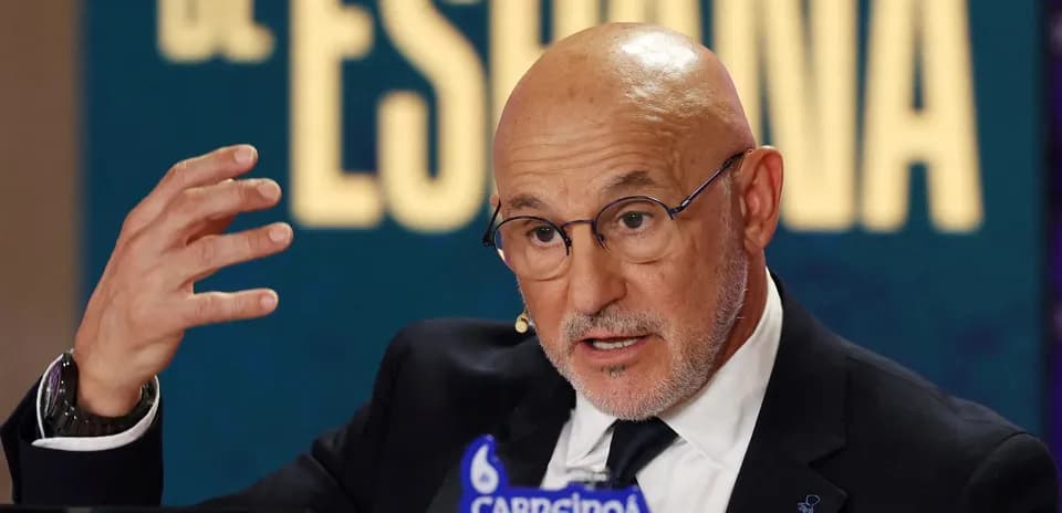 Man speaking at press conference with gesturing hand