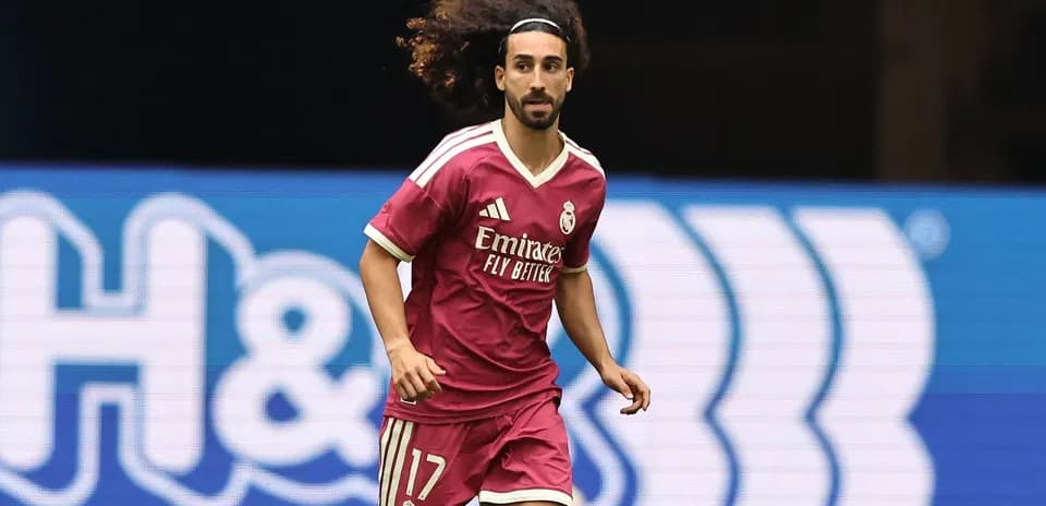 Player running in pink Real Madrid kit on field