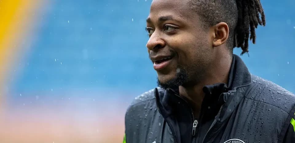 Player smiling during training in rainy conditions
