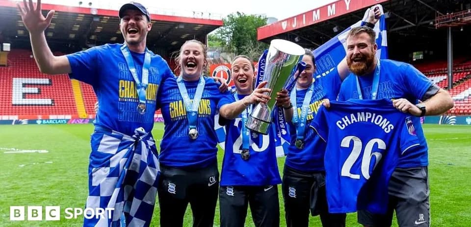 Celebrating team with trophy and championship shirts