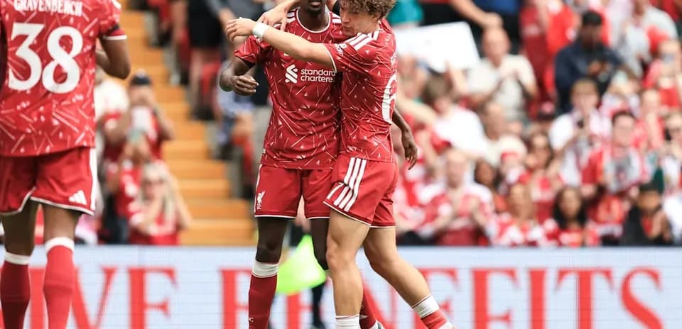 Liverpool players celebrating together on the pitch