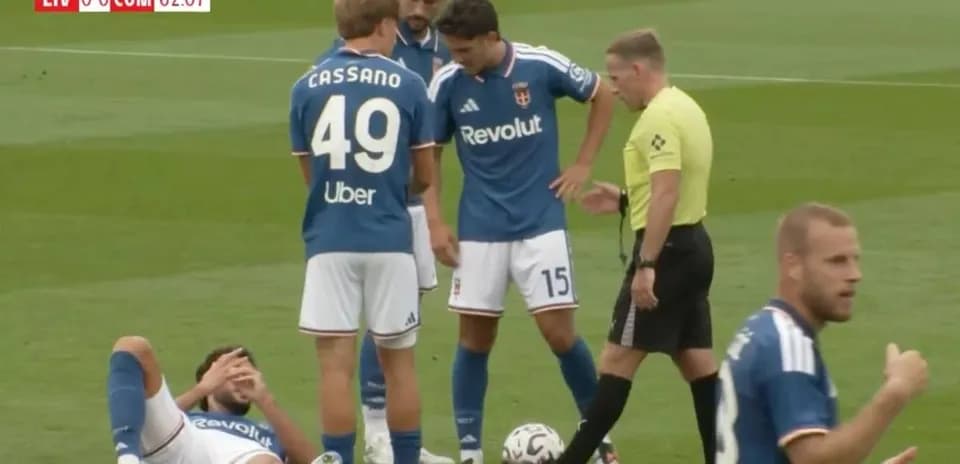 Players gathered around an injured teammate on field