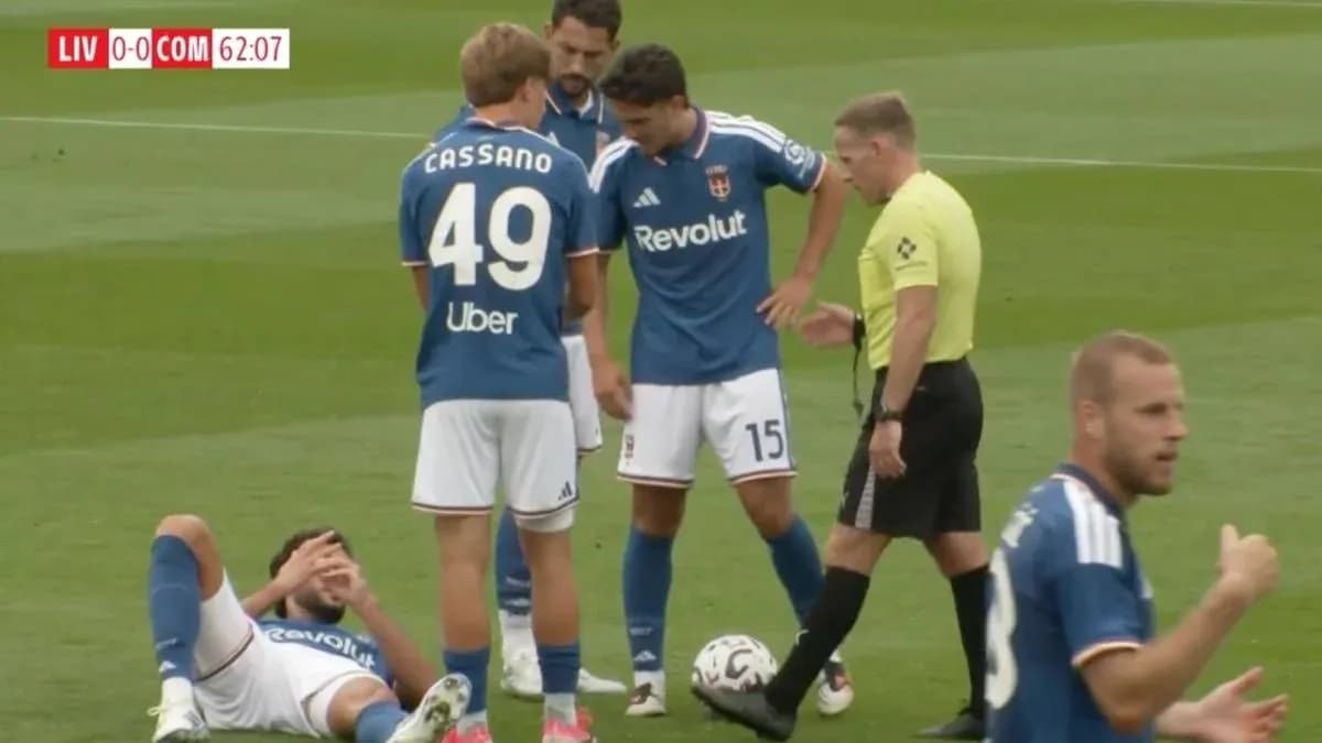 Players gathered around an injured teammate on field