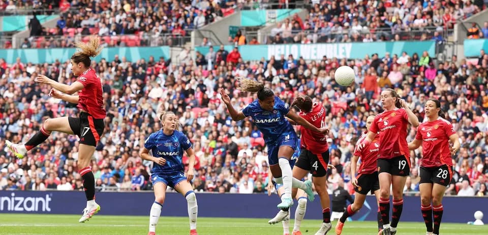 Players competing for the ball during FA WSL match