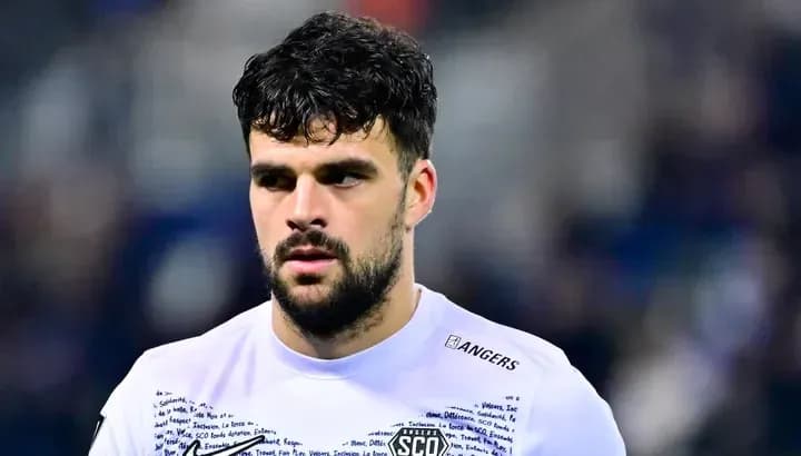 Football player wearing Angers SCO jersey on field