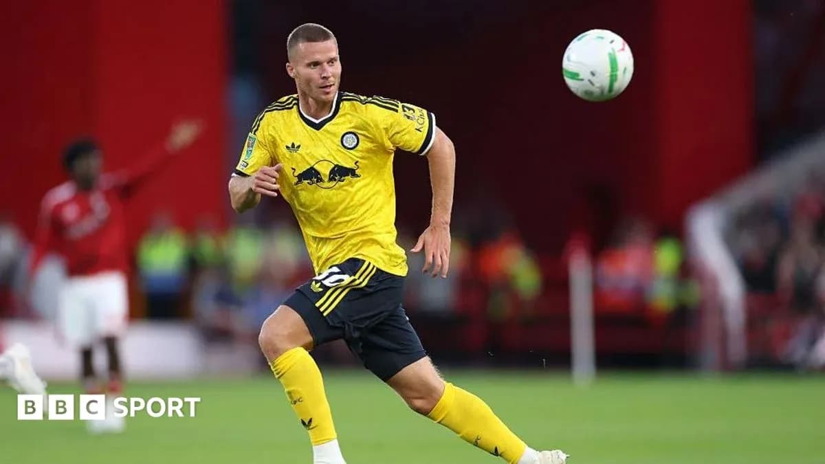 Player in yellow kit chasing a flying football