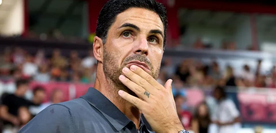 Manager observing the match with thoughtful expression