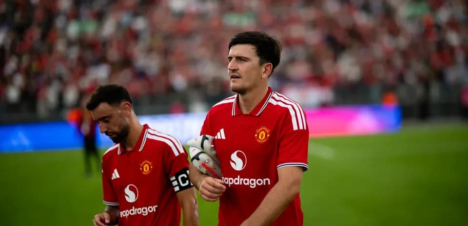 Two Manchester United players walking off the pitch