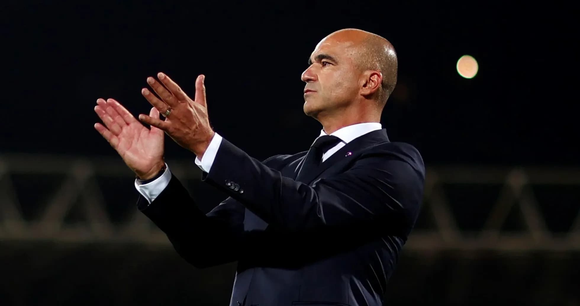 Coach applauding during a football match