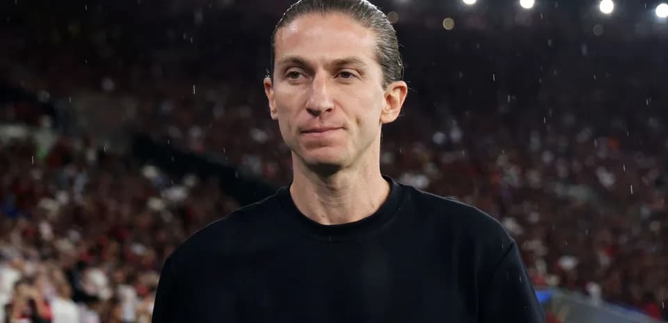 Coach on the sidelines during a rainy match