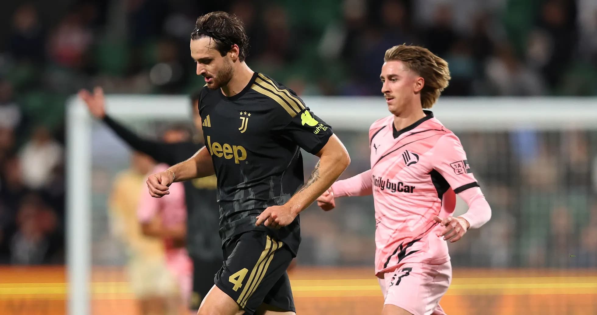 Juventus player running with opponent in pursuit