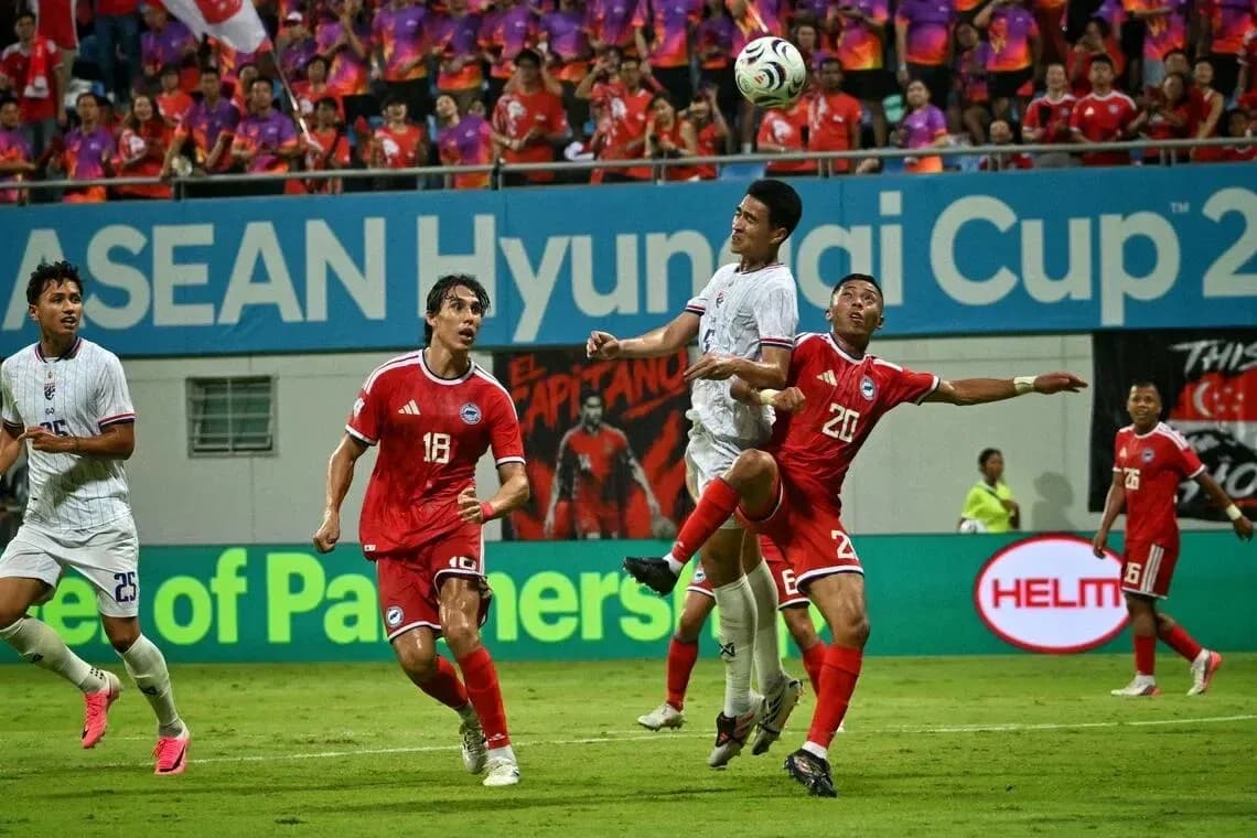 Players competing for the ball during ASEAN Cup match