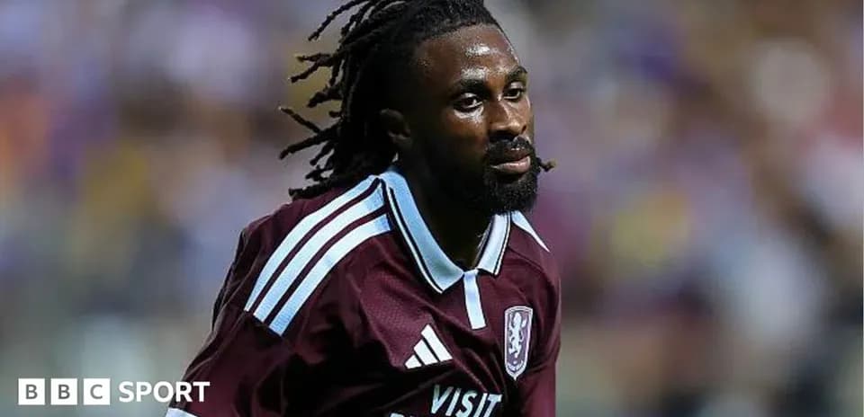 Player in maroon kit running on the pitch