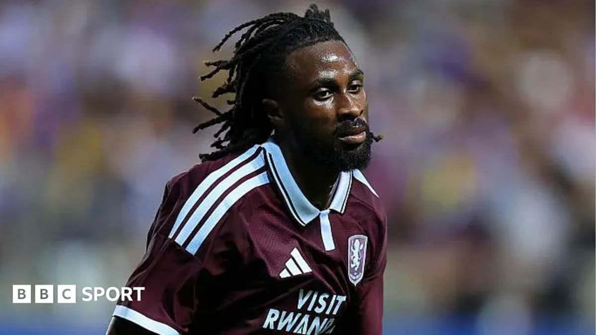Player in maroon kit running on the pitch