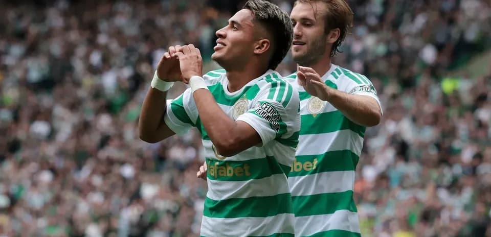 Celtic players celebrating a goal at home stadium