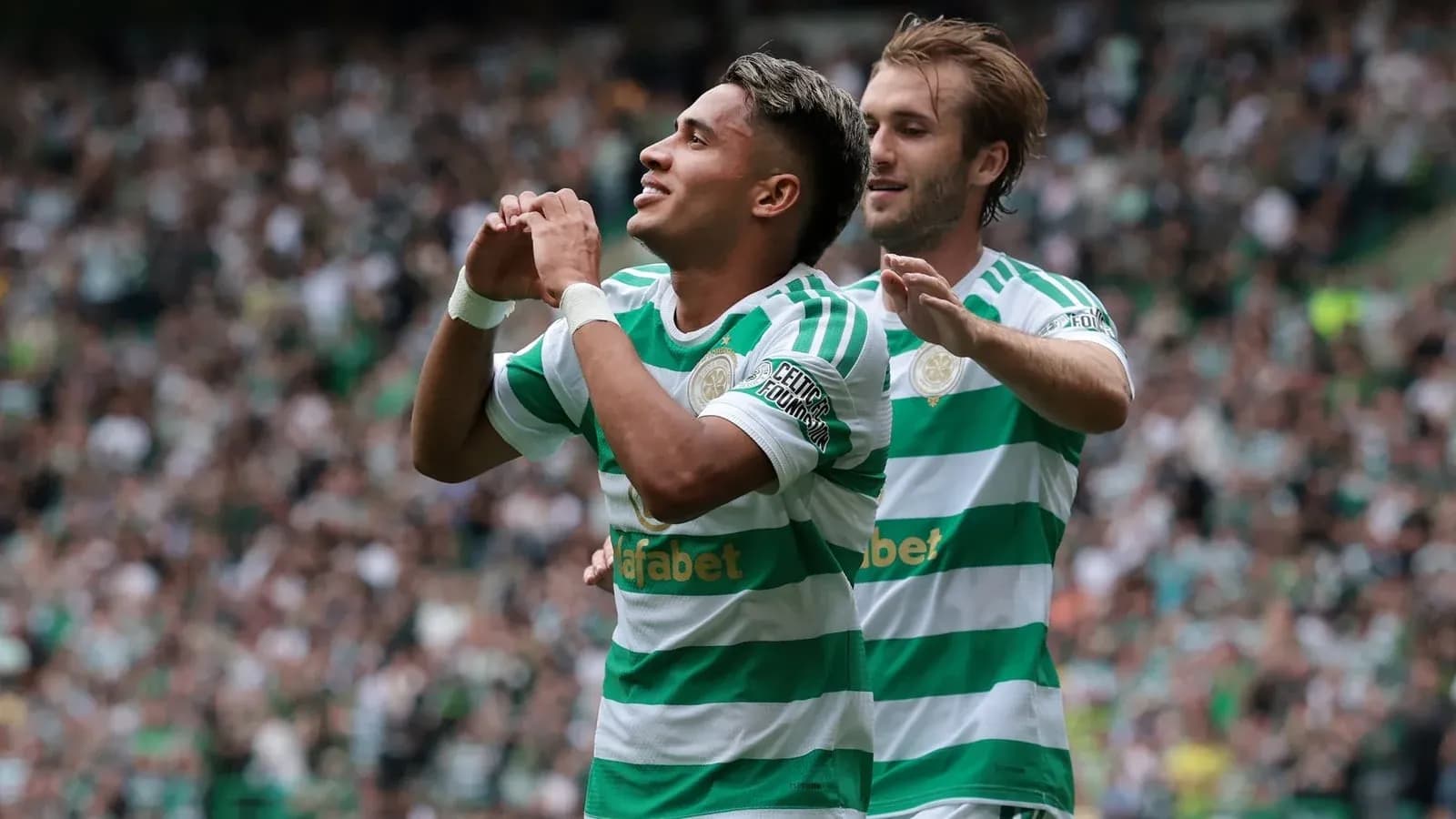 Celtic players celebrating a goal at home stadium
