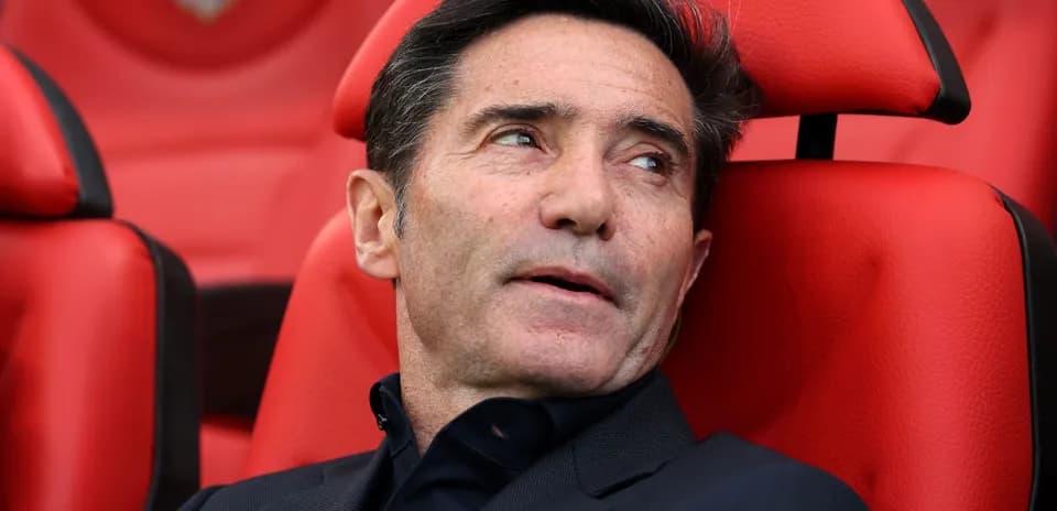 Coach sitting on bench during match