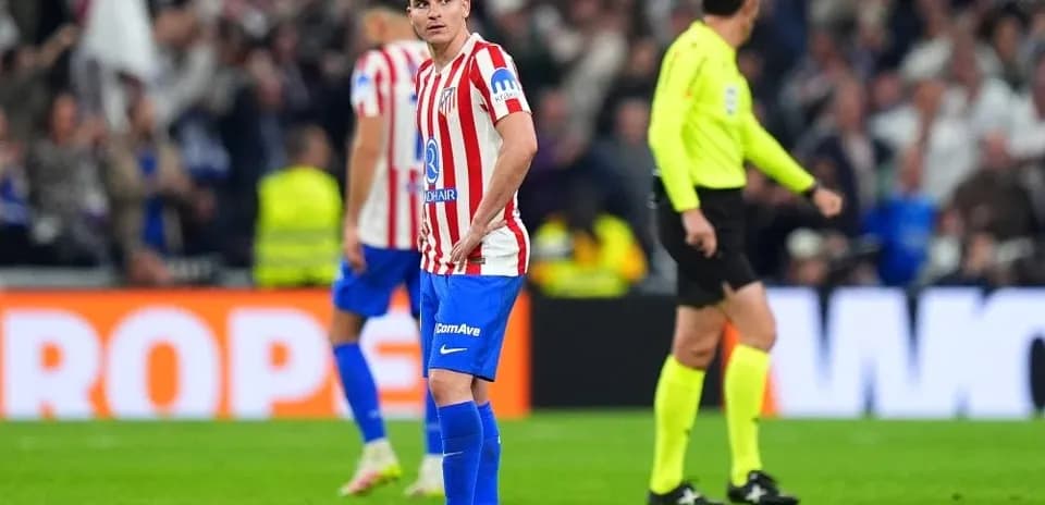 Atletico Madrid player reacts during match with referee