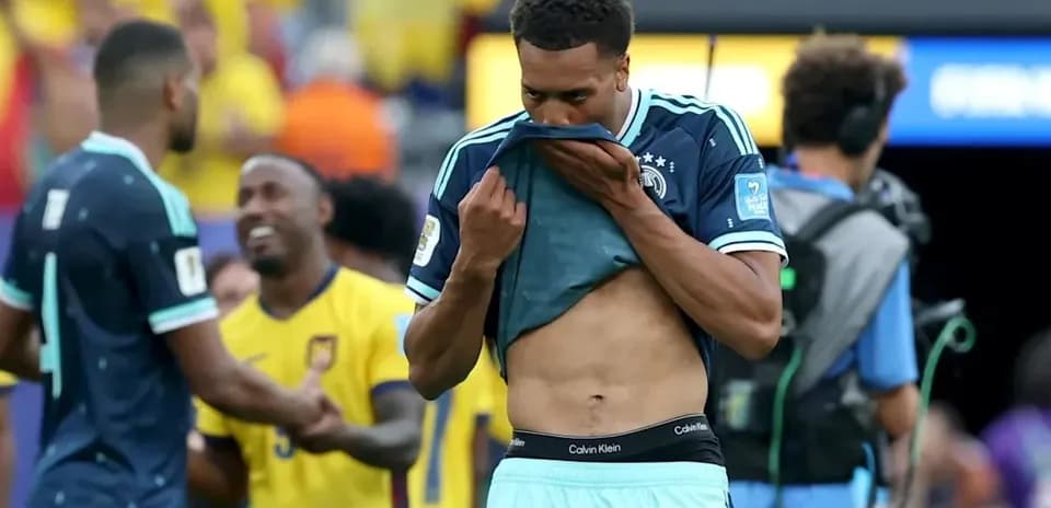 Player removing shirt after match in stadium