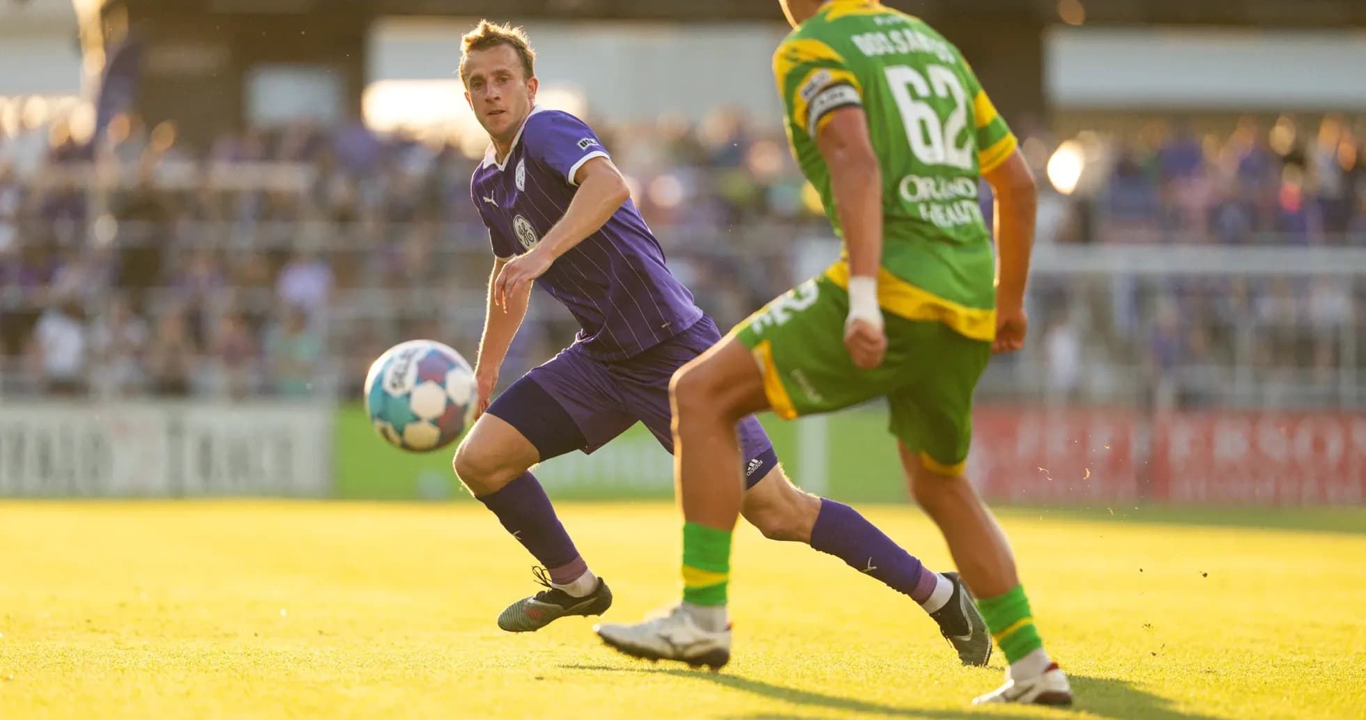 Louisville City player passing the ball during match