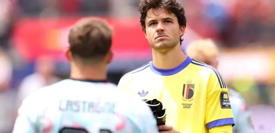 Goalkeeper in yellow kit looking towards teammate