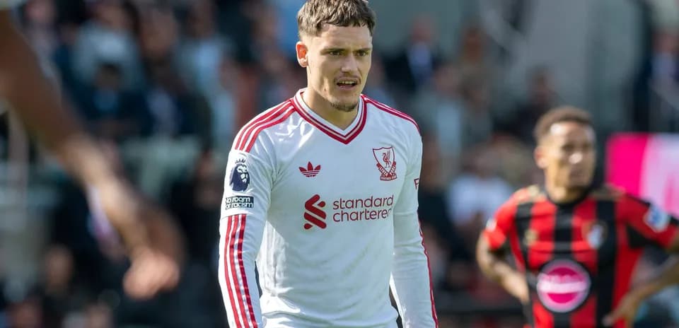 Liverpool player wearing white kit during match