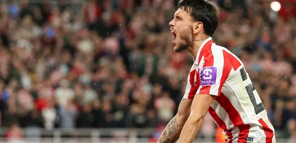 Player celebrating passionately in front of fans