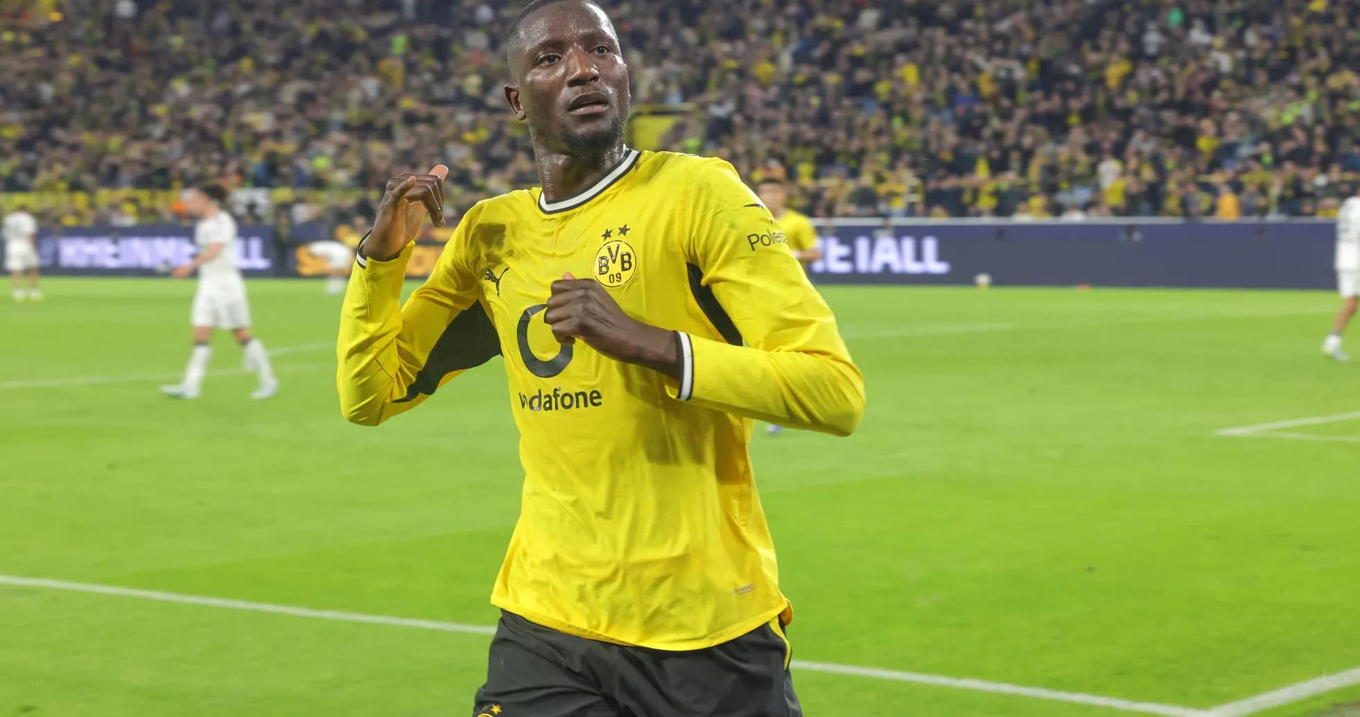 Player celebrating a goal in Borussia Dortmund kit